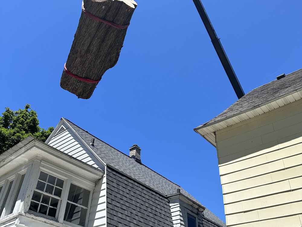 Crane lift over residential rooftop